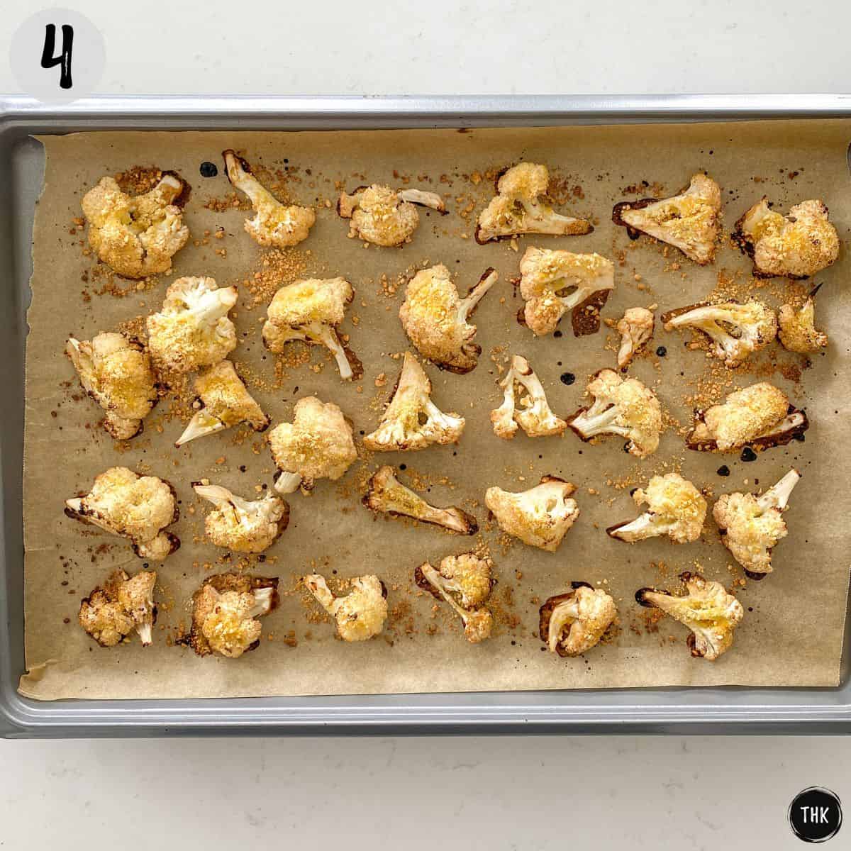 Golden brown cauliflower florets on baking tray.