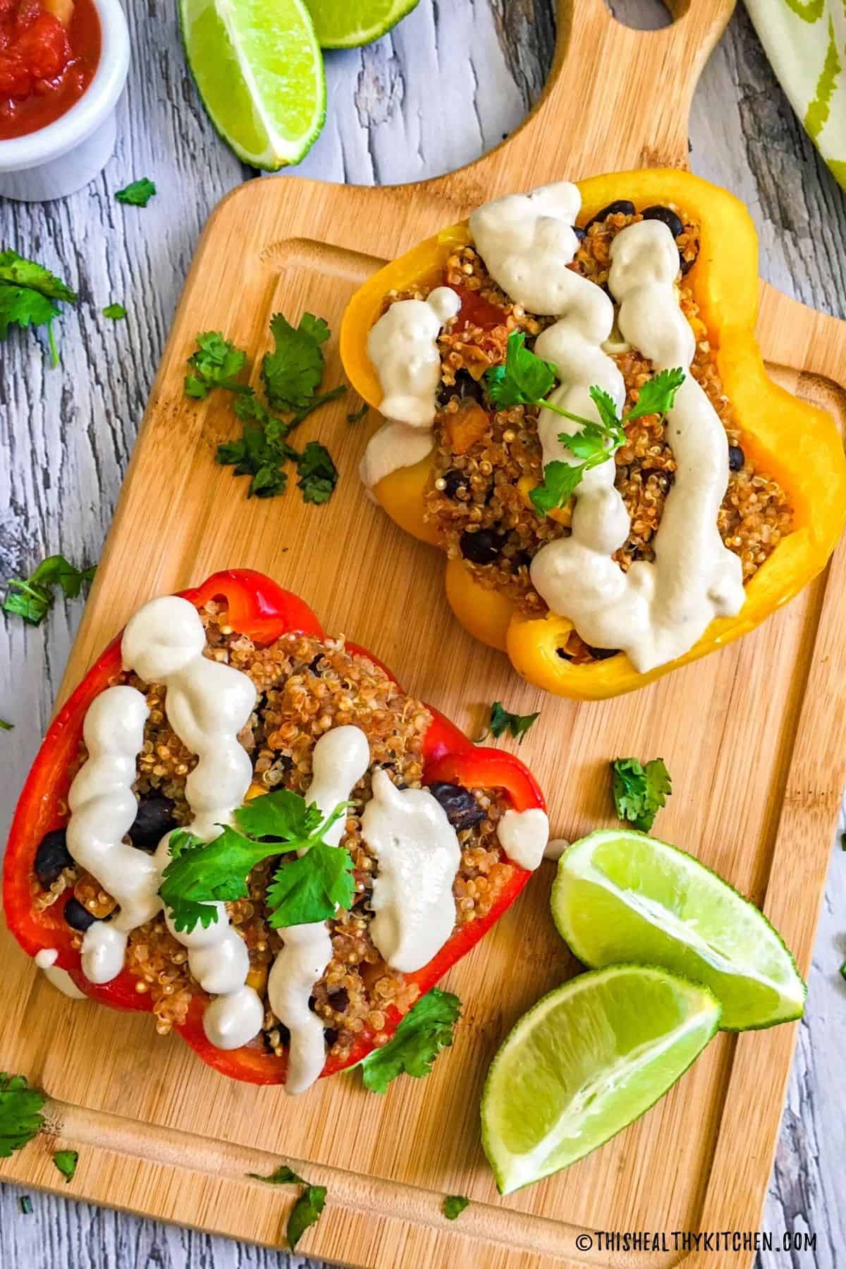Bell pepper halves stuffed with quinoa, beans, corn and topped with cheese sauce.