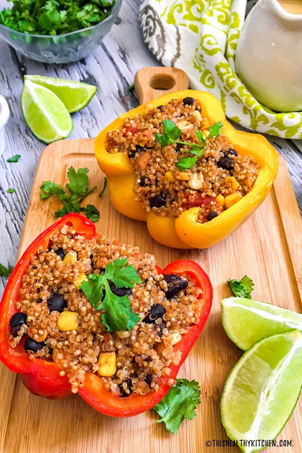 Mexican stuffed peppers on cutting board with cilantro on top and lime on the side.