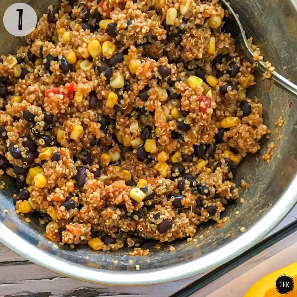Large mixing bowl filled with cooked quinoa, black beans, corn, salsa and seasoning.
