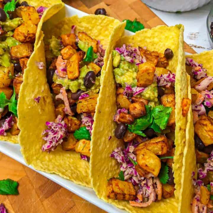 Corn tortillas stuffed with potatoes, black beans and coleslaw.