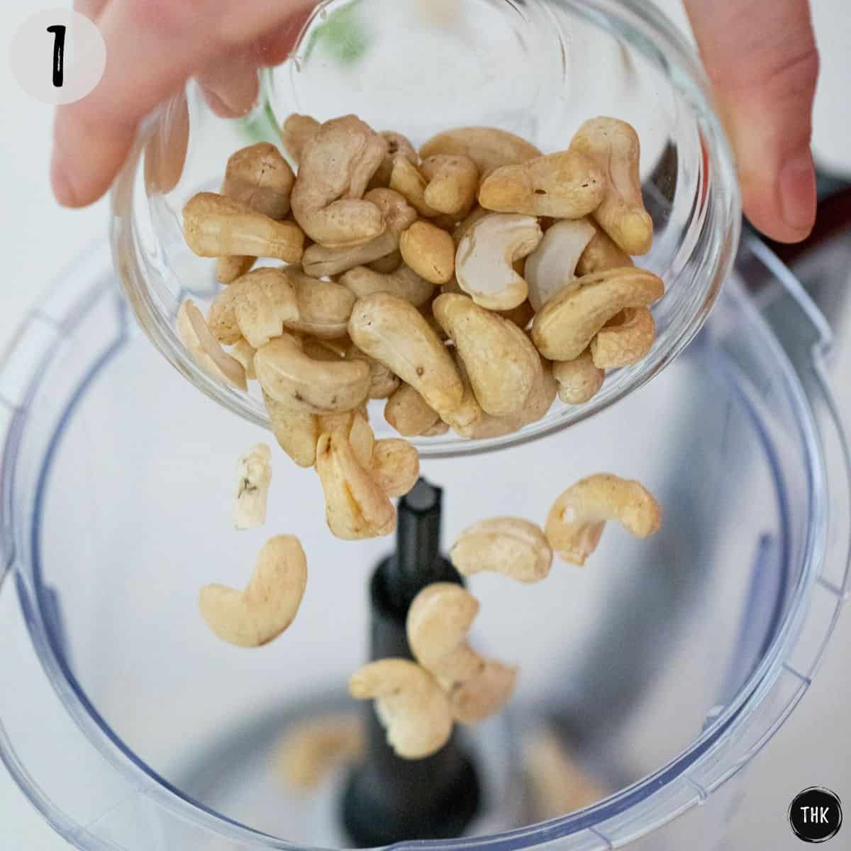 Cashews being poured into blender.
