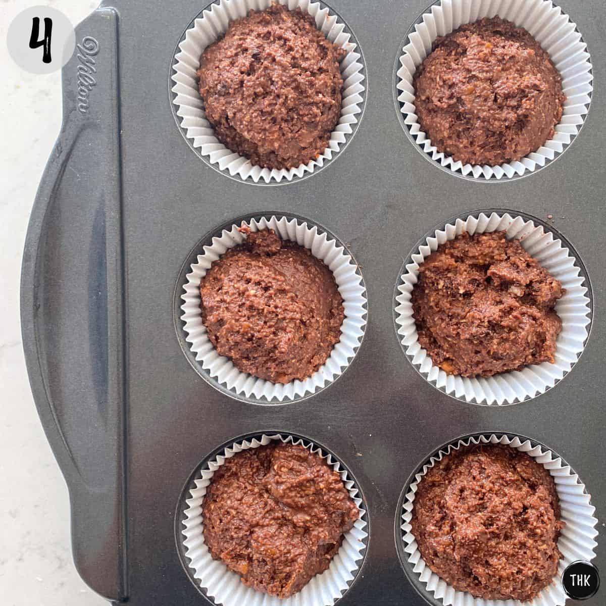 Raw cupcake batter in muffin pan before baking.