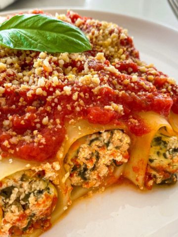 Side view of stuffed vegan cannelloni with ricotta and spinach filling.
