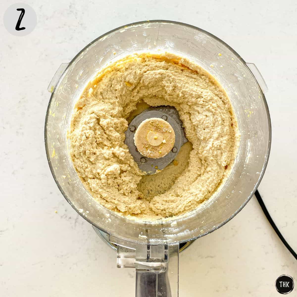 Cheese mixture inside bowl of food processor.