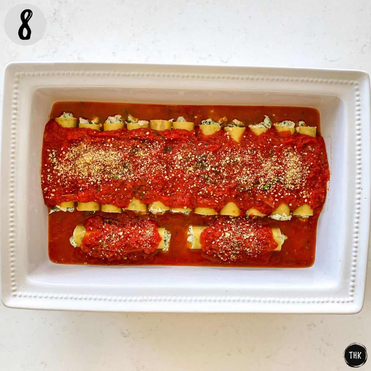Cannelloni stuffed with cheese and spinach in baking dish.