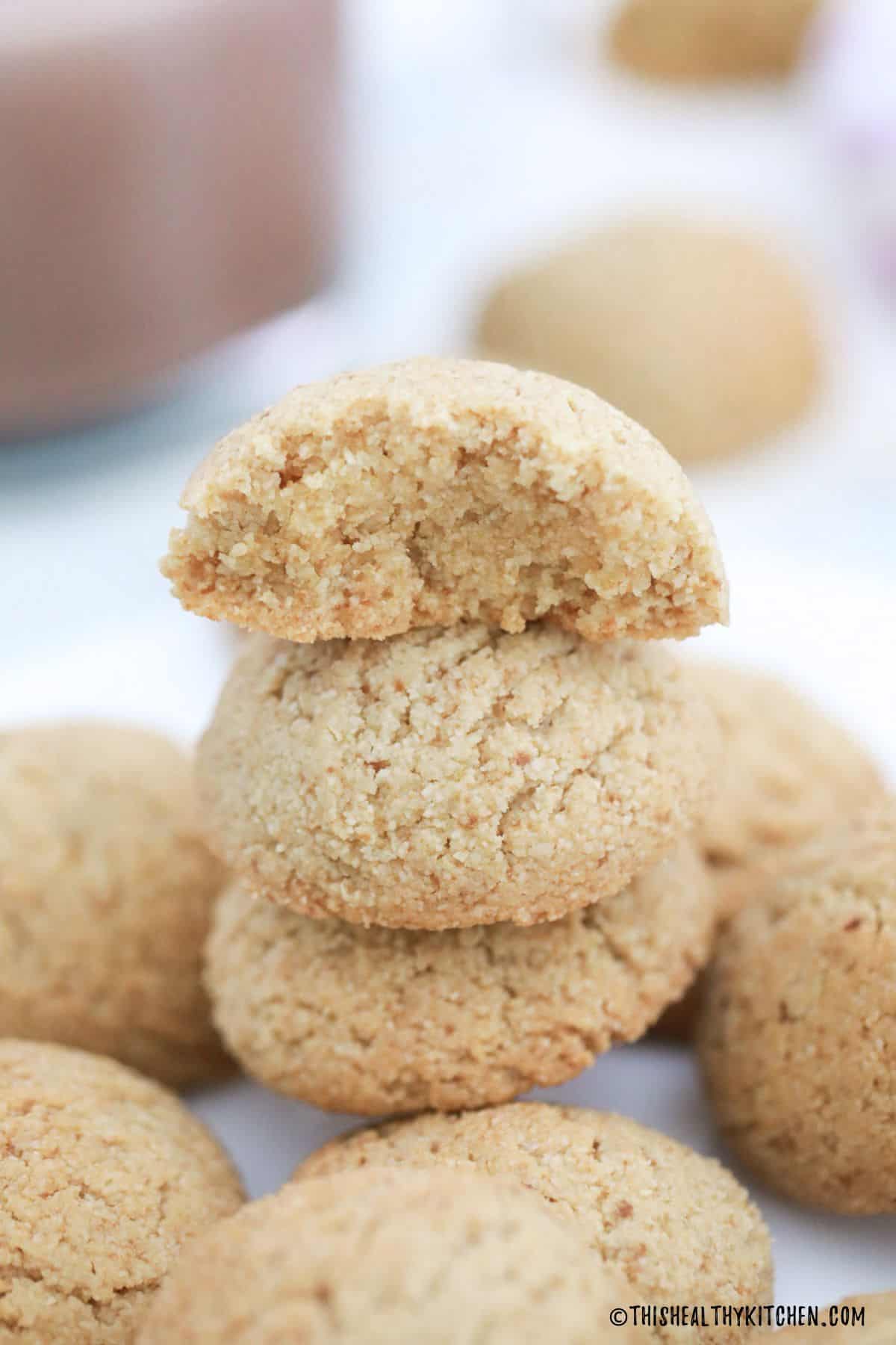 Almond flour cookies in a stack with top one cut in half.