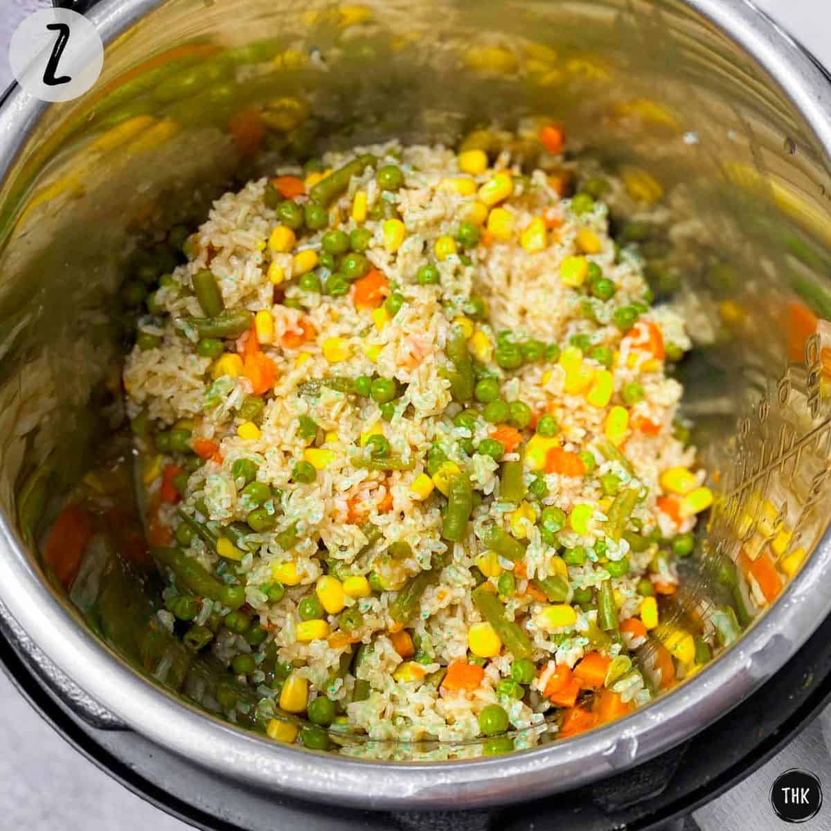 Instant Pot with cooked rice and veggies inside.