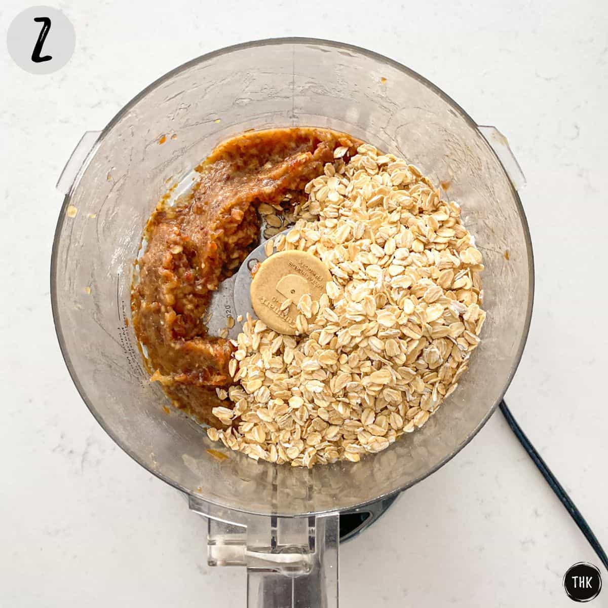 Pureed dates and rolled oats inside food processor.