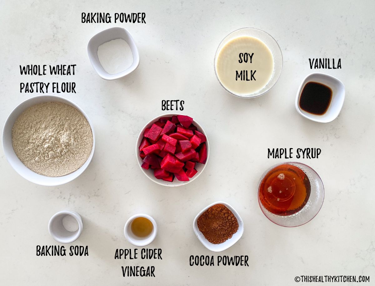 Ingredients needed to make vegan red velvet cupcakes on kitchen countertop.