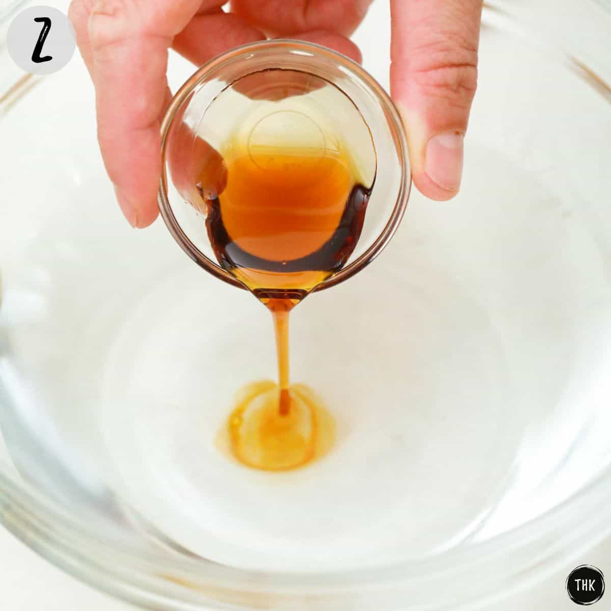 Maple syrup being poured into bowl of water.