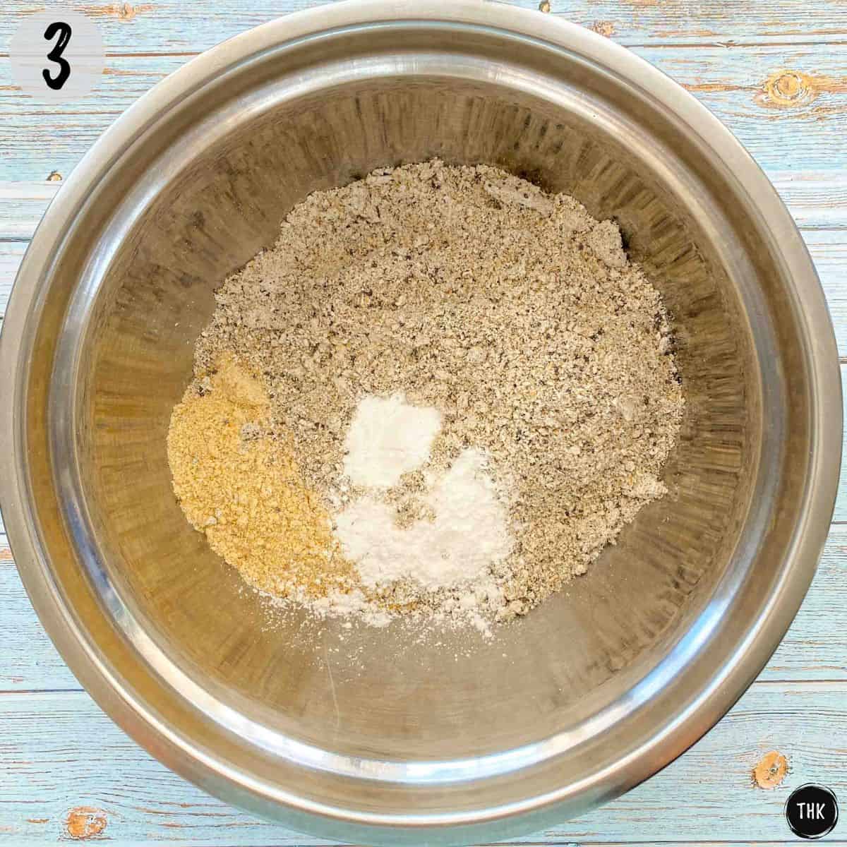 Mixing bowl with chickpea flour, ground oats, baking powder and chia seeds.