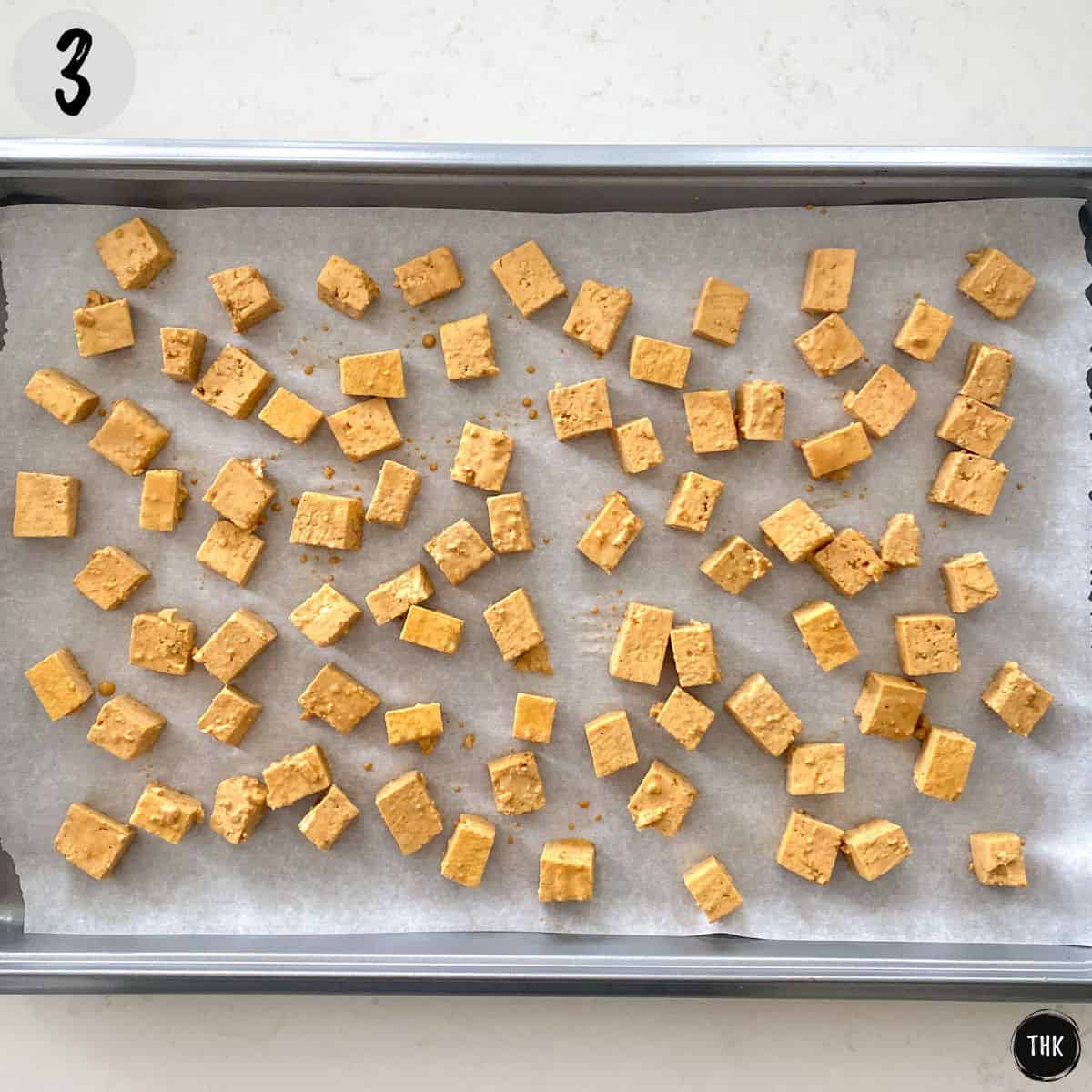 Tofu cubs on baking sheet.