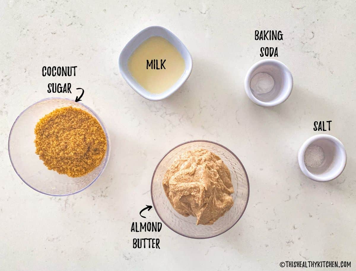 Ingredients needed to make almond butter cookies on kitchen counter.