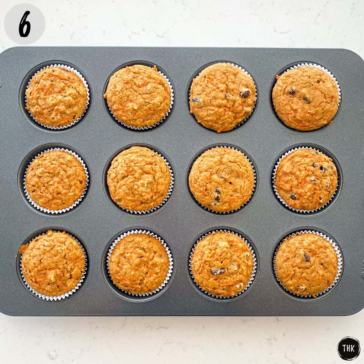Baked vegan carrot cupcakes inside muffin pan.