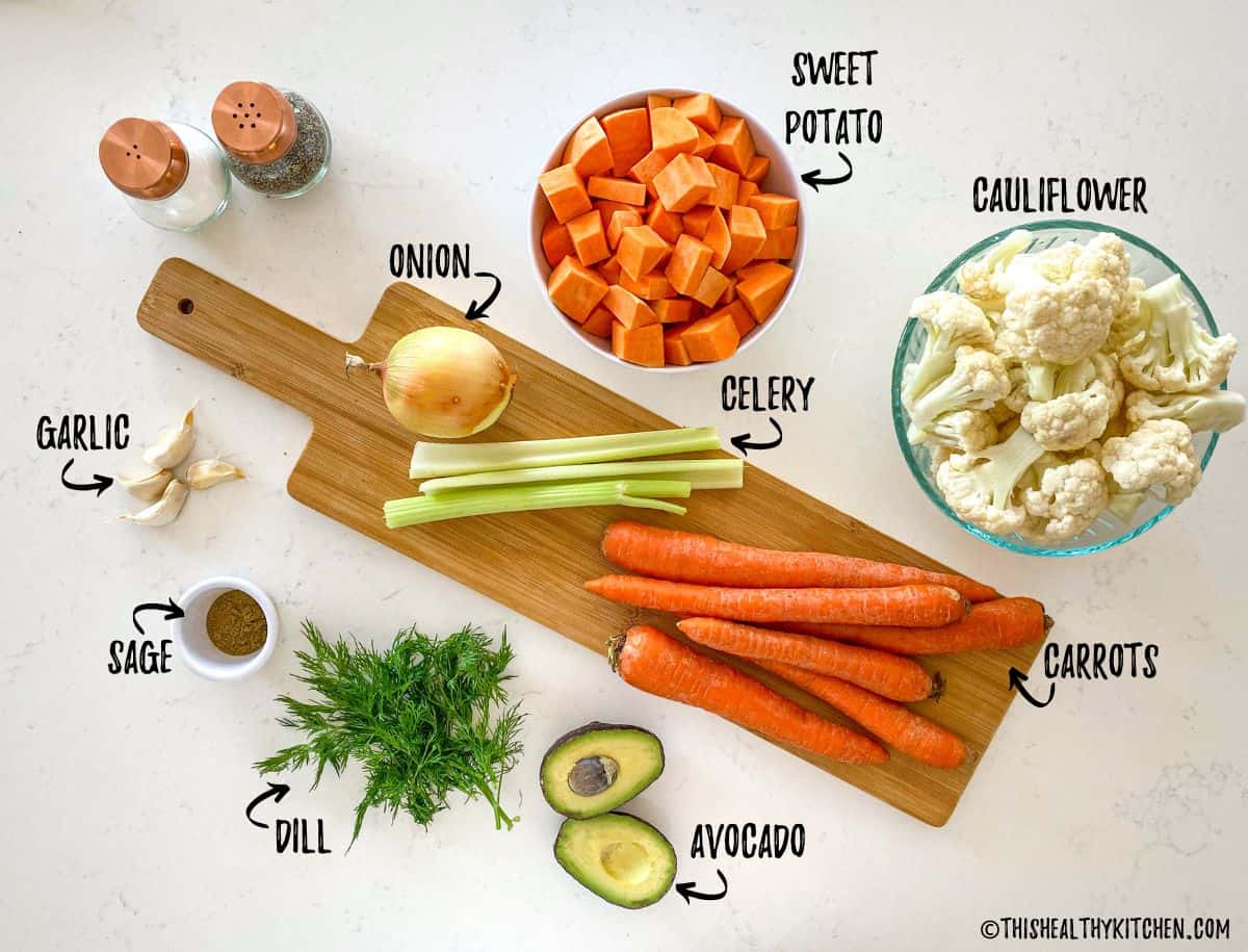 Ingredients needed to make carrot cauliflower soup on kitchen counter top.
