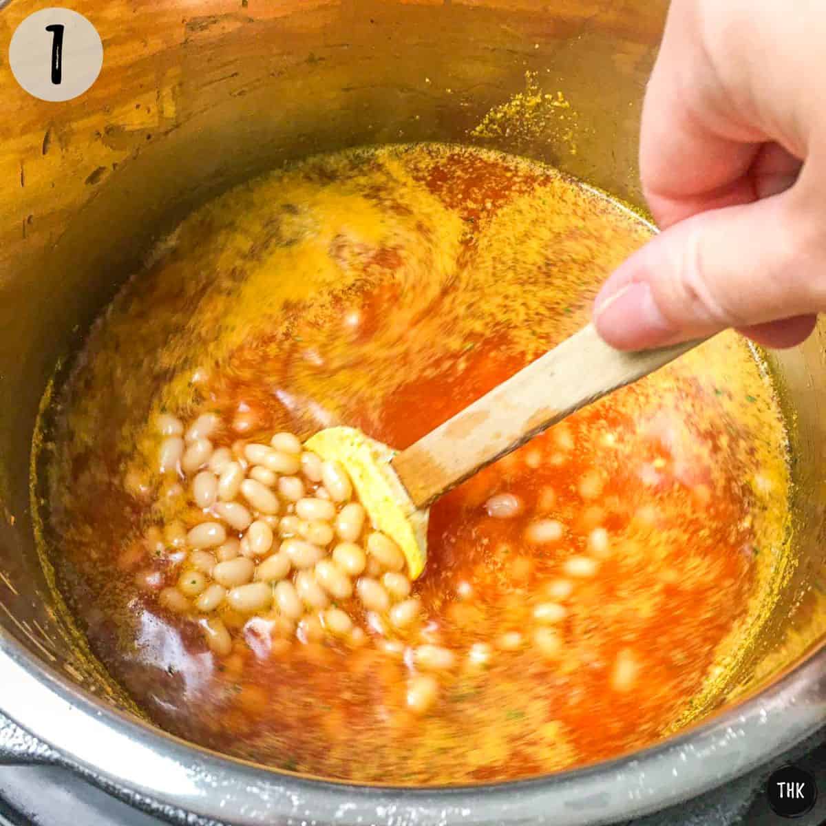 Beans and sauce with broth inside Instant Pot.