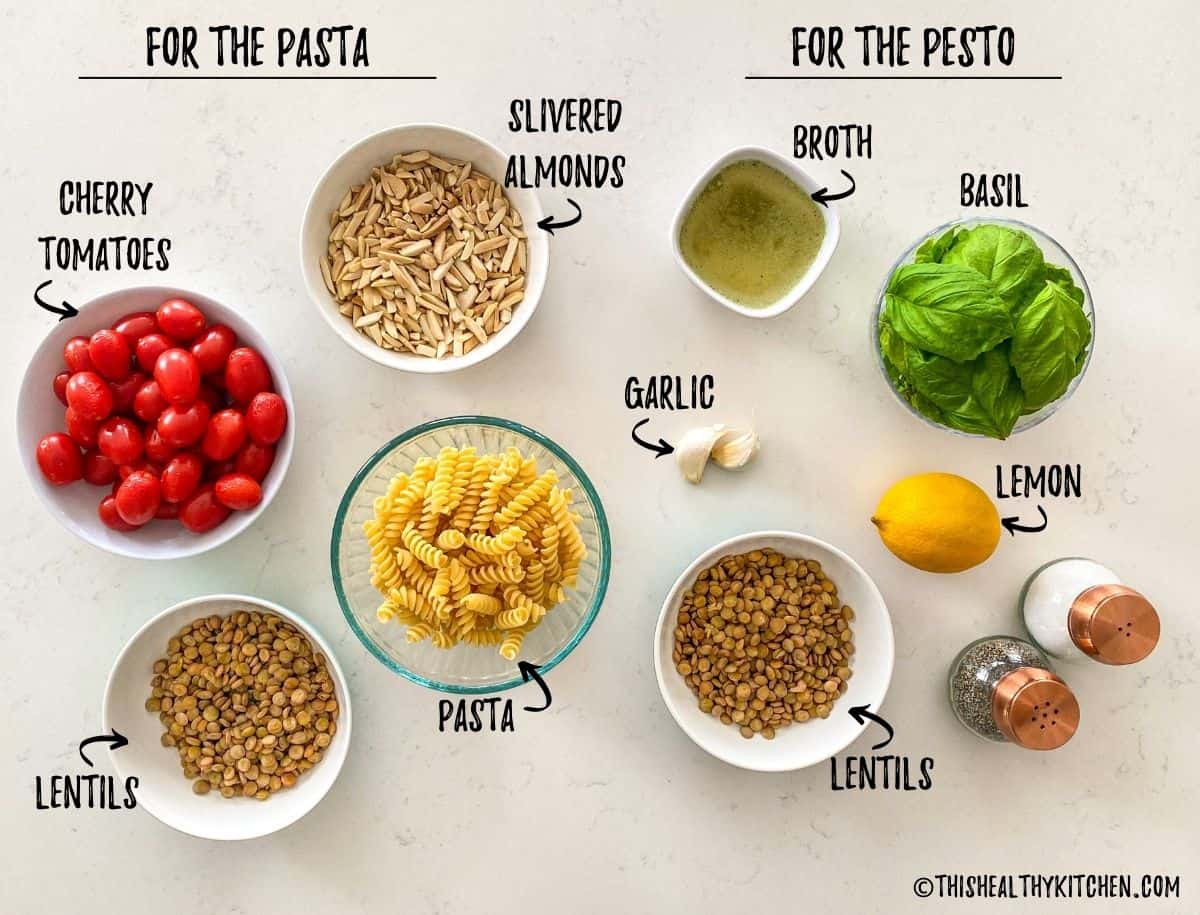 Ingredients needed to make lentil pesto pasta salad on kitchen counter.