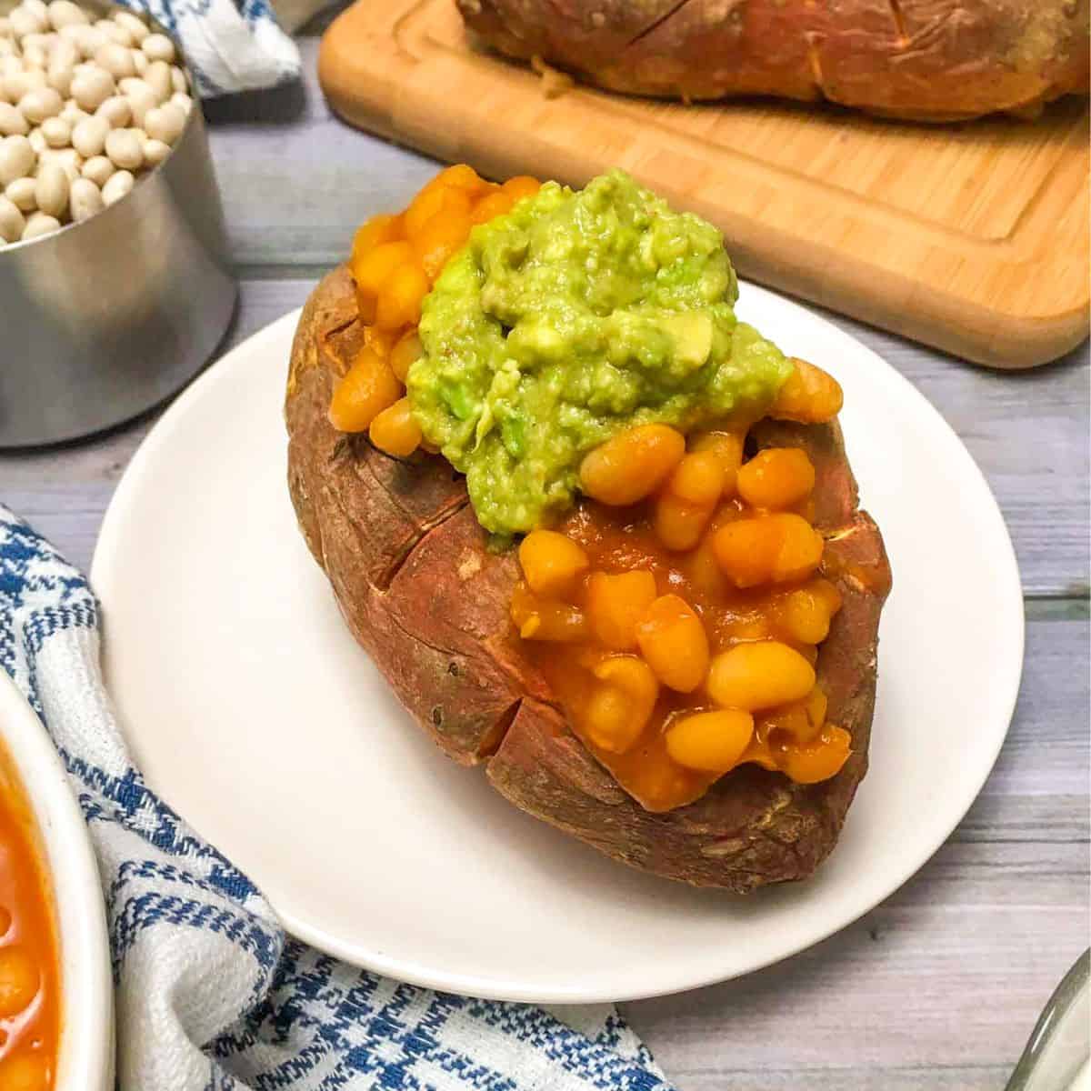 Loaded sweet potato with baked beans and guacamole.