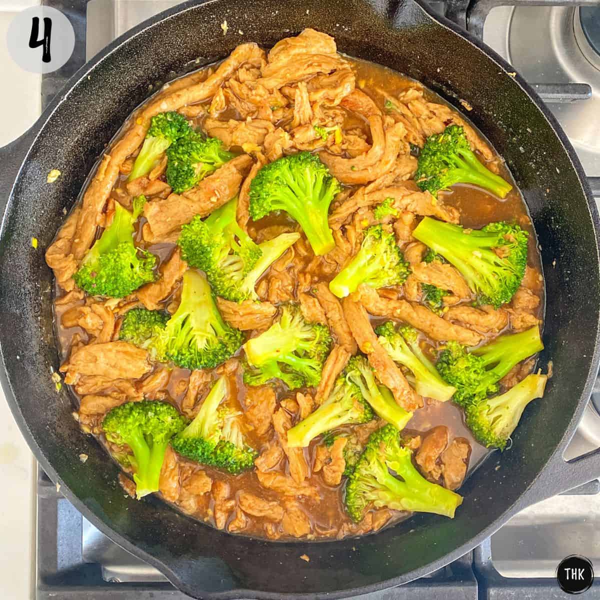 Soy curls, broccoli and brown sauce inside cast iron pan.
