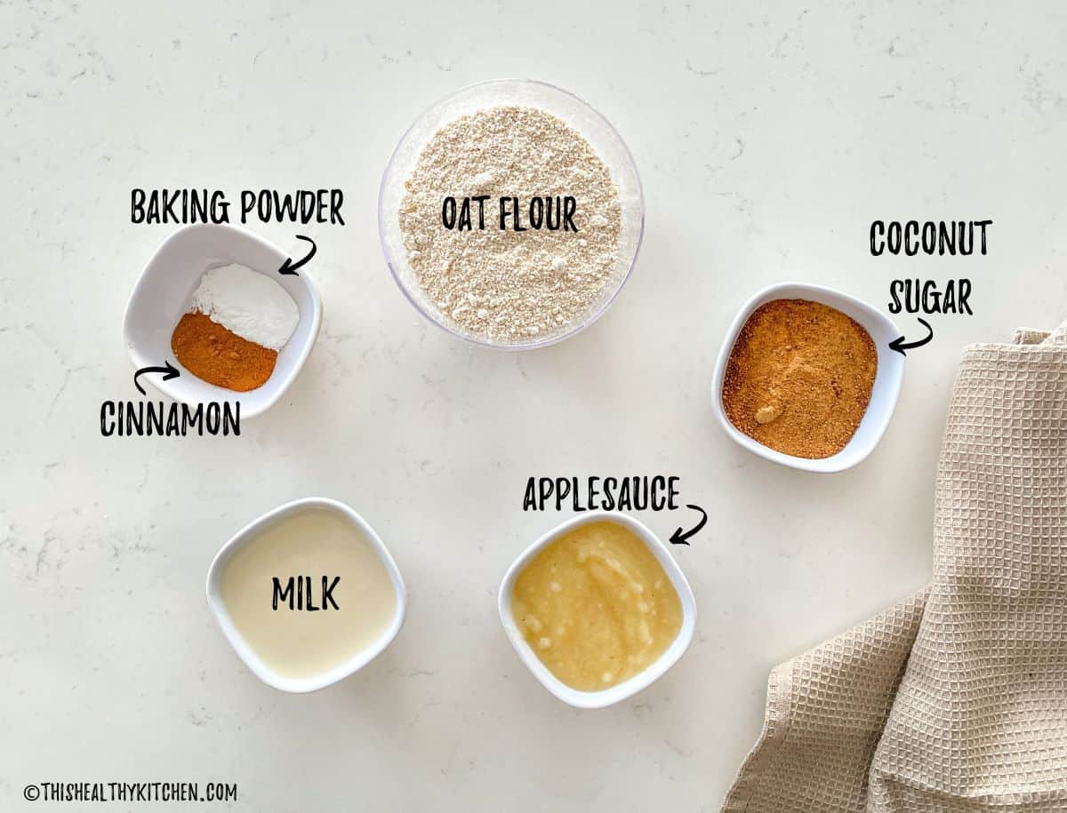 Bowl of oat flour, coconut sugar, applesauce, milk, cinnamon and baking powder.