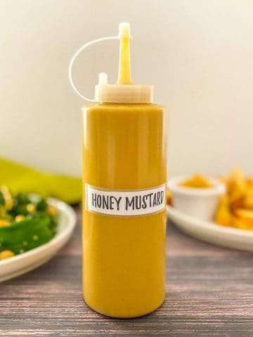 Bottle of yellow sauce labelled honey mustard.