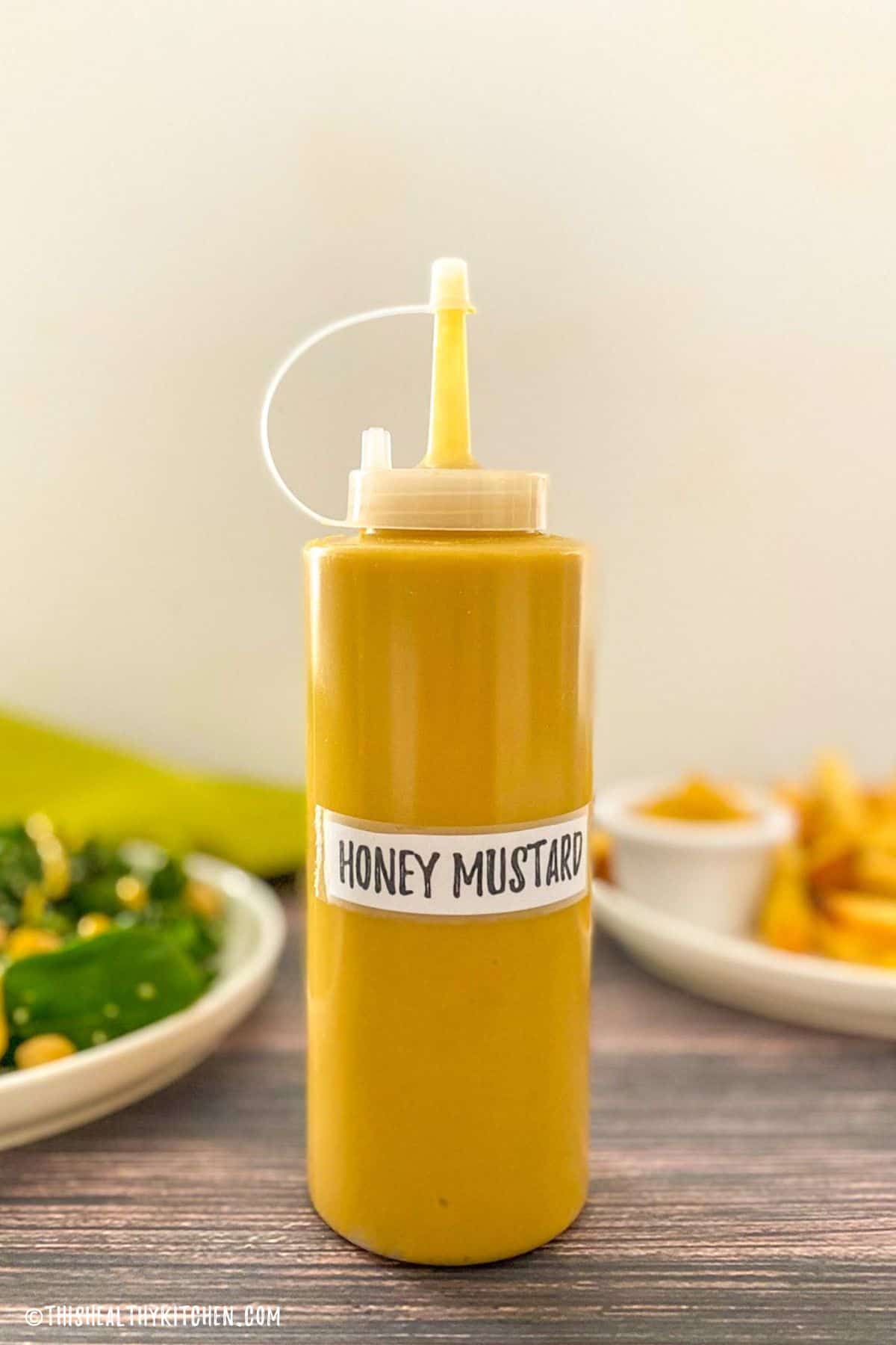 Bottle of yellow sauce labelled honey mustard.