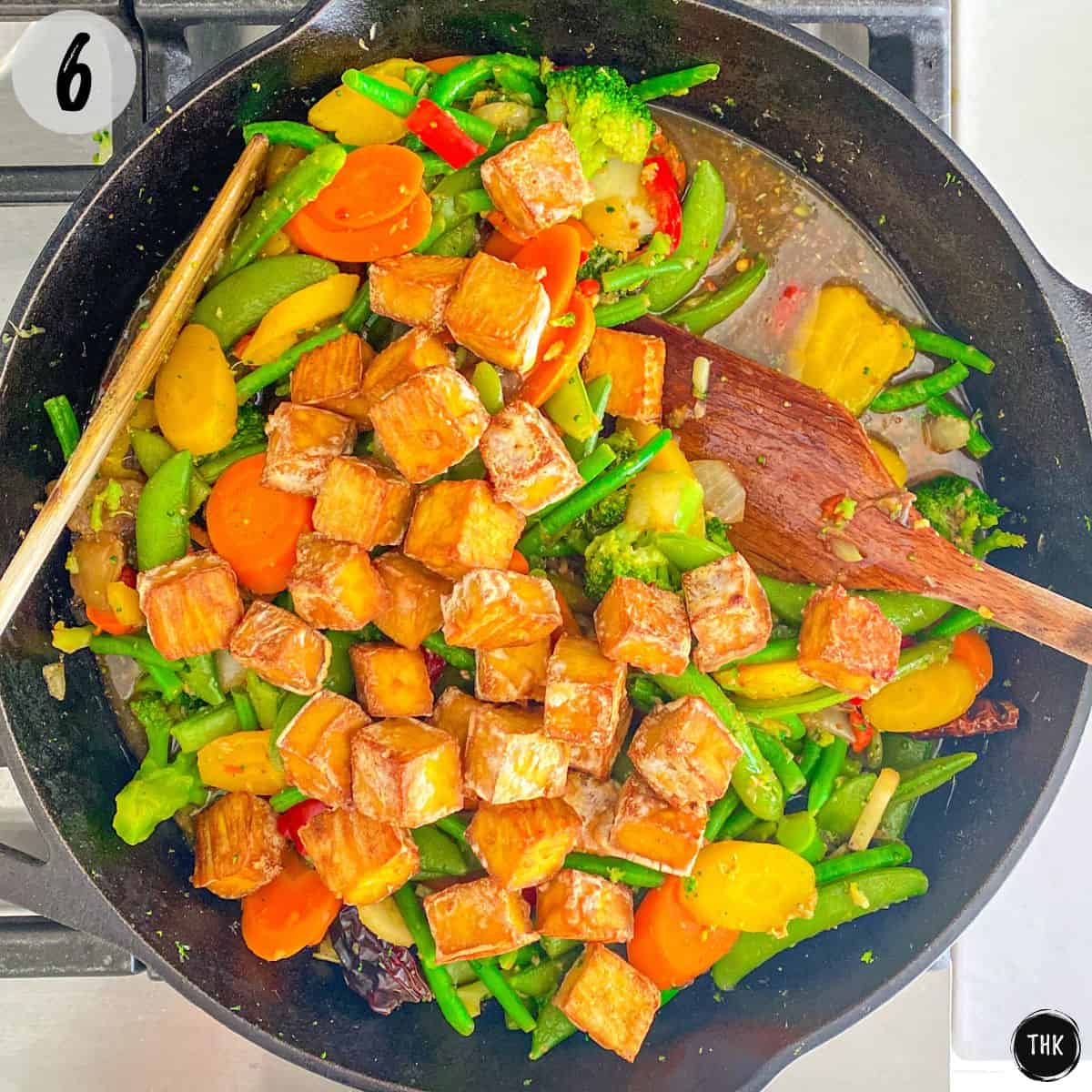 Tofu and veggies in large cast iron pan.