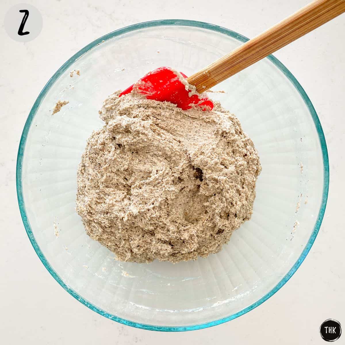 Batter mixture inside large glass bowl.