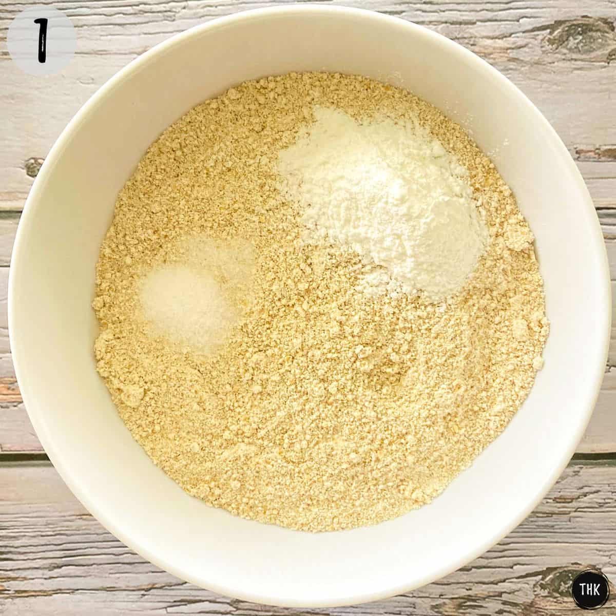 White bowl with flour and baking powder inside.