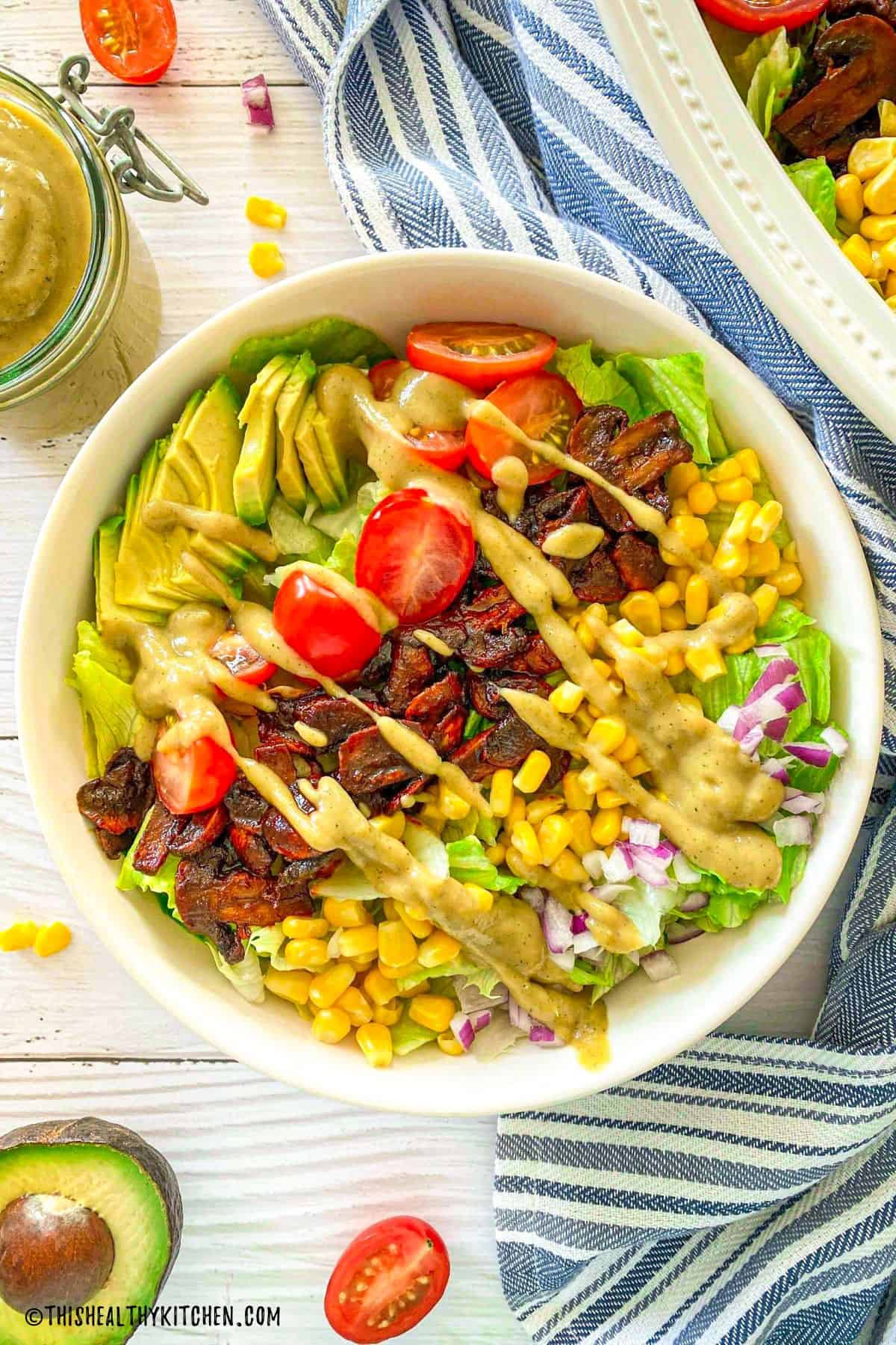 Vegan cobb salad with cheesy dressing on top.