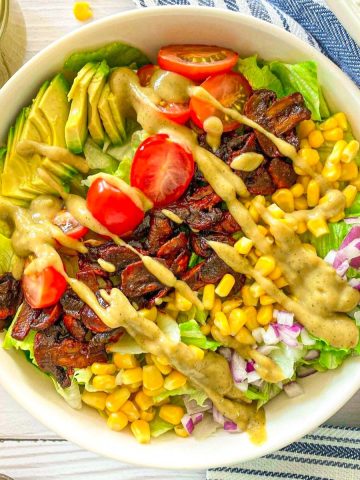 Vegan cobb salad with cheesy dressing on top.