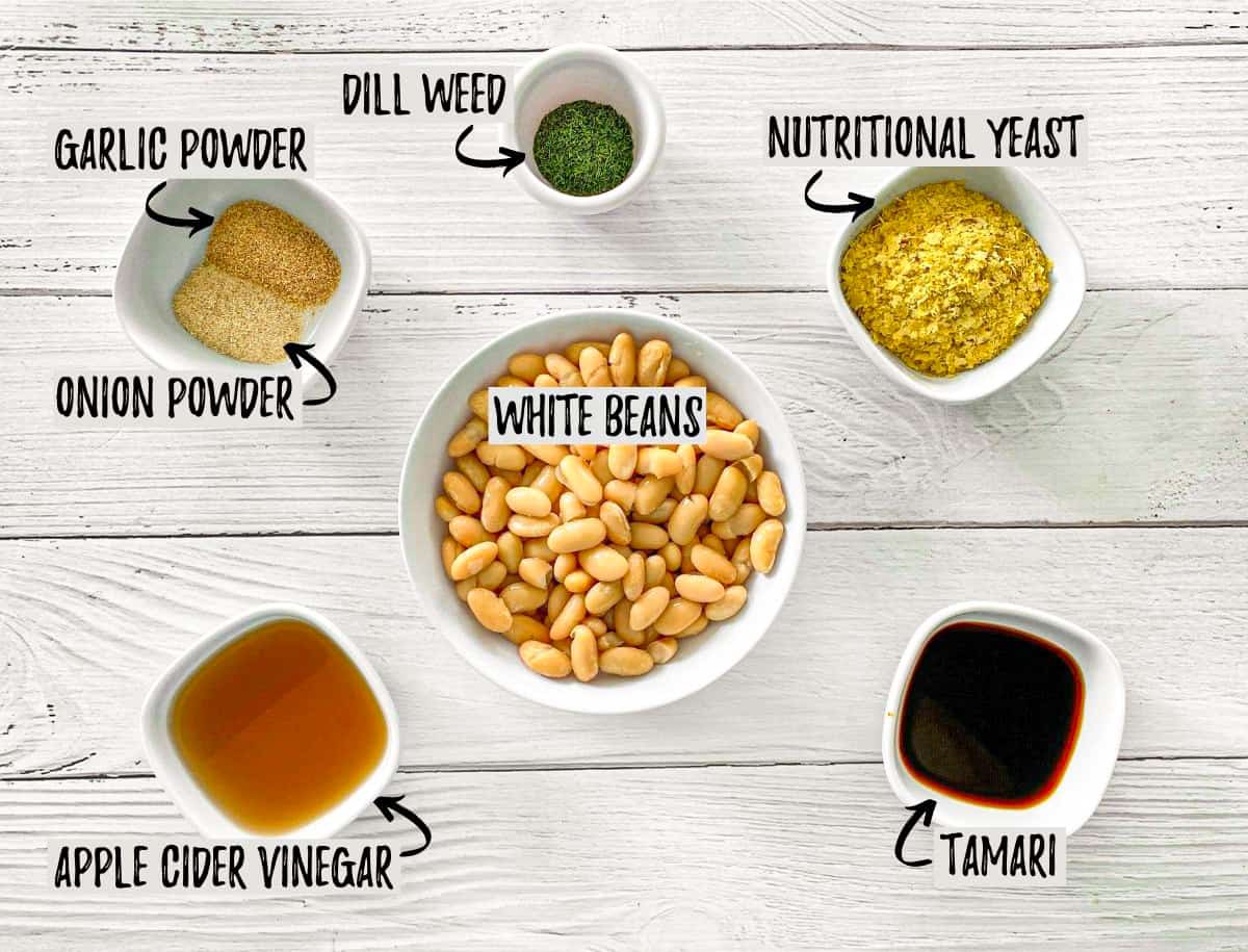 Ingredients to make vegan cheesy dressing in prep bowls.