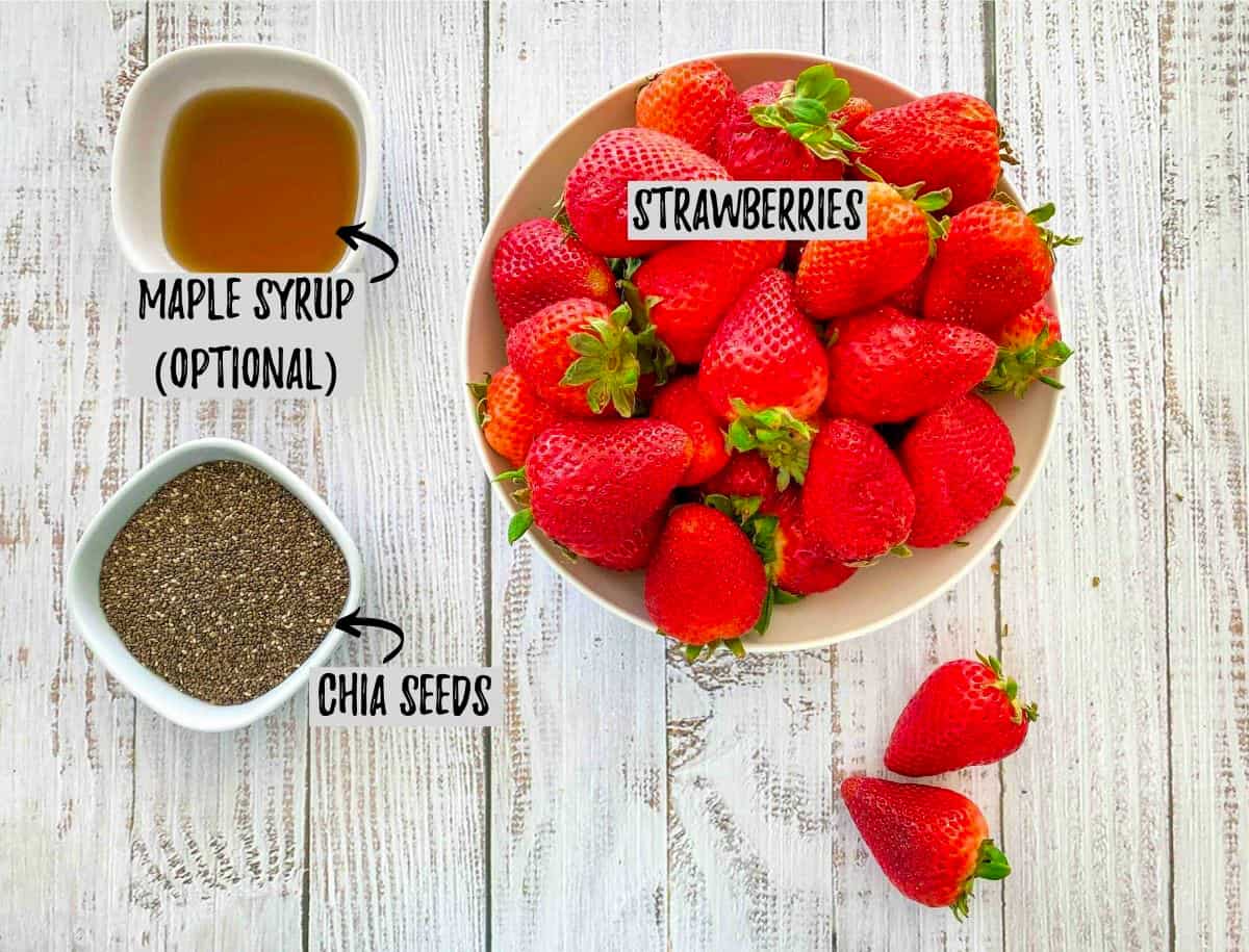 Strawberries, maple syrup and chia seeds in prep bowls.