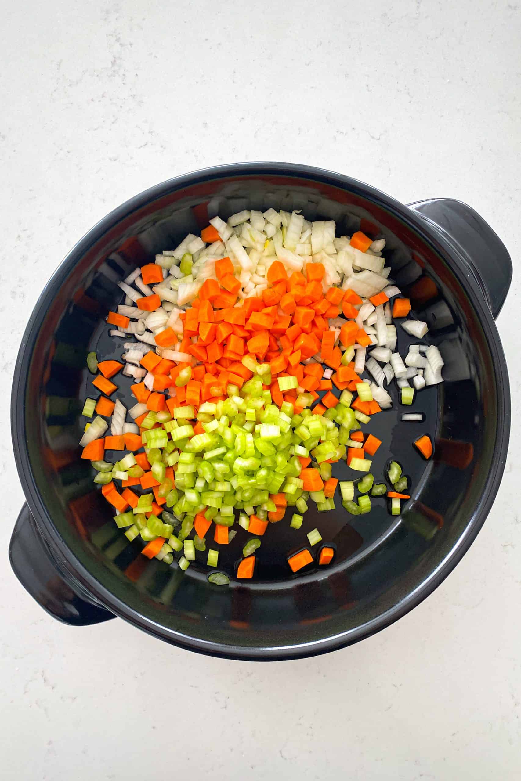 Xtrema versa pan with chopped onion, carrot and celery inside.
