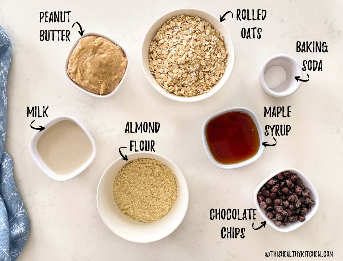 Ingredients needed to make peanut butter oatmeal cookies on countertop.