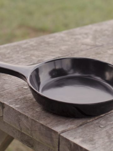 Ceramic frying pan on picnic bench.