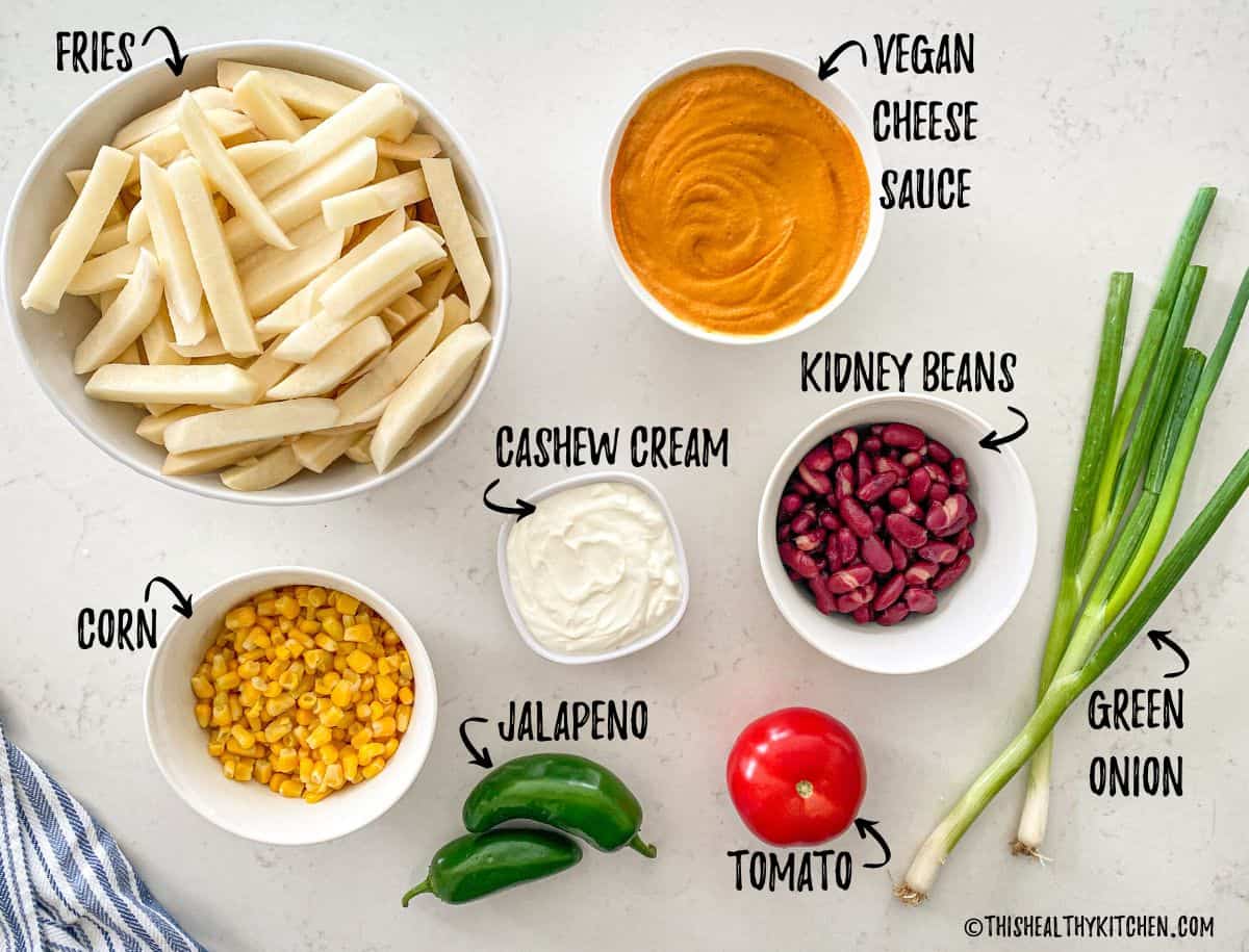 Ingredients needed to make vegan loaded fries on kitchen counter.