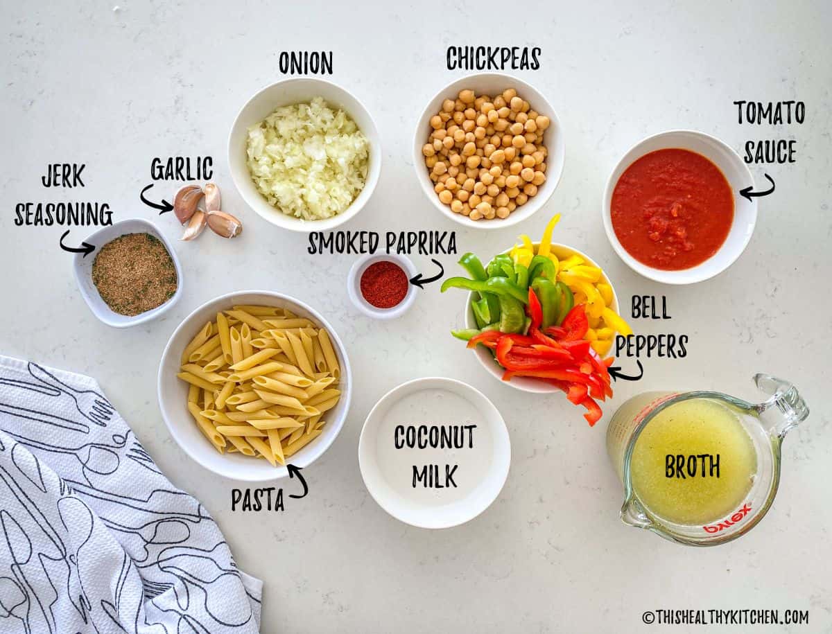 Ingredients needed to make vegan rasta pasta in prep bowls on countertop.