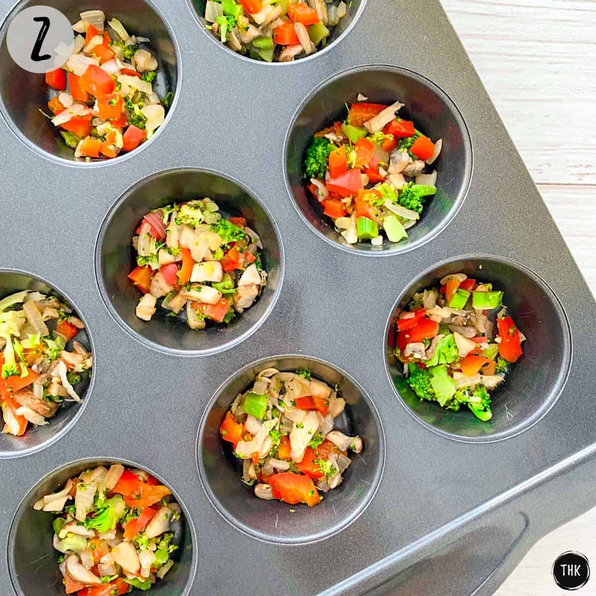 Muffin pan with finely chopped veggies inside.