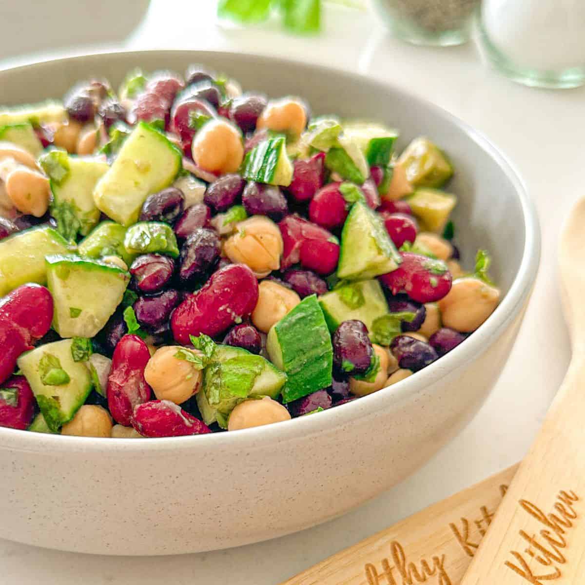 Vegan bean salad in white serving bowl.