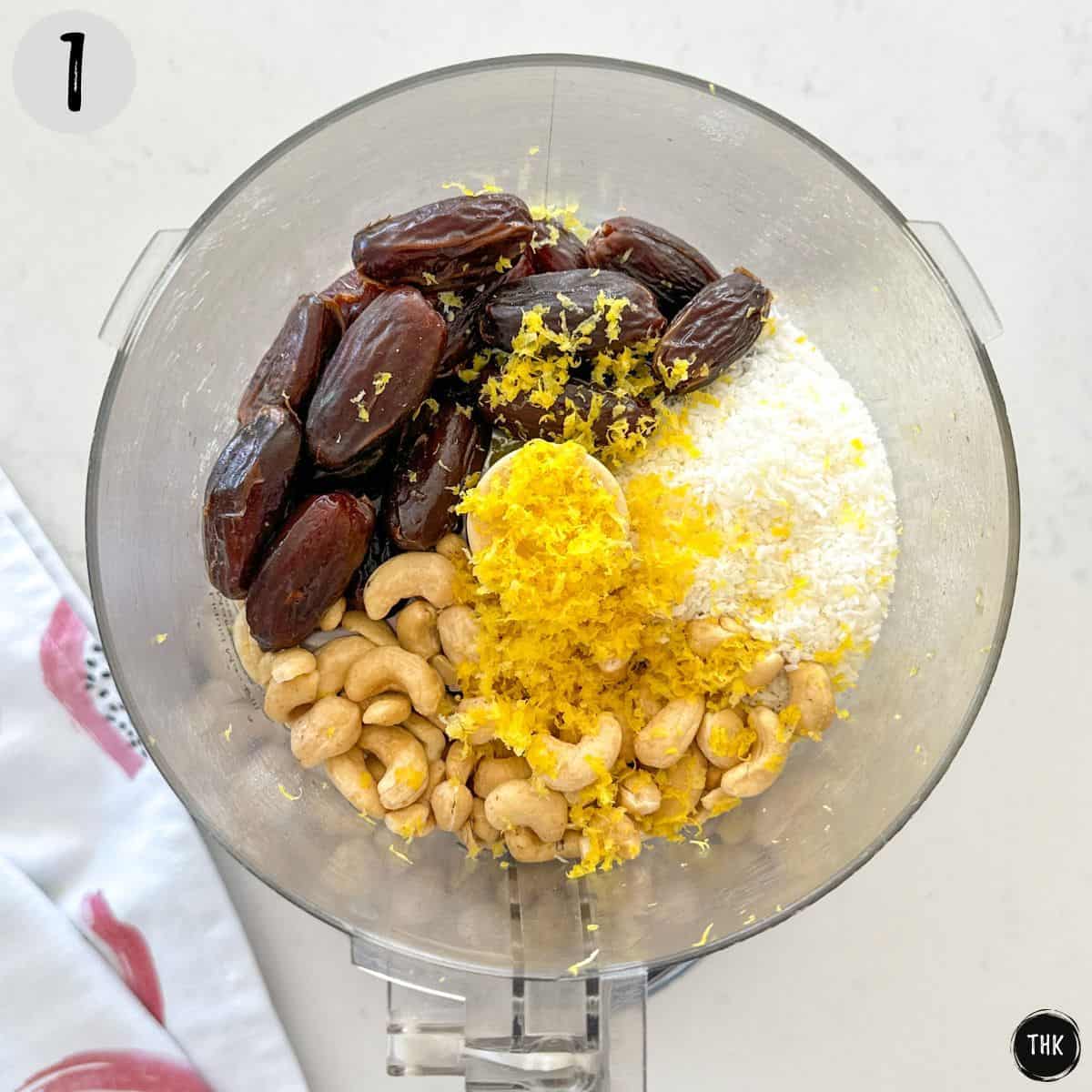 Dates, cashews, coconut and lemon zest inside food processor bowl.