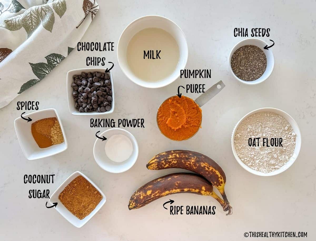 Ingredients needed to make pumpkin banana muffins on kitchen countertop.