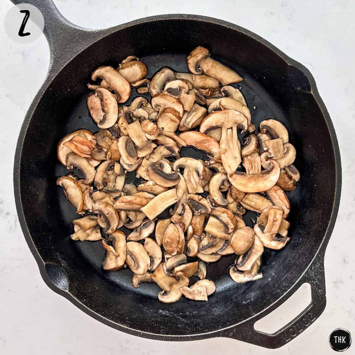 Sautéed mushrooms in cast iron pan.