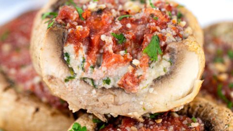 Stuffed portobello mushroom sliced in half.