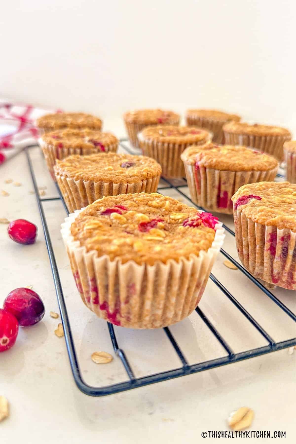 Vegan cranberry muffins on cooling rack.