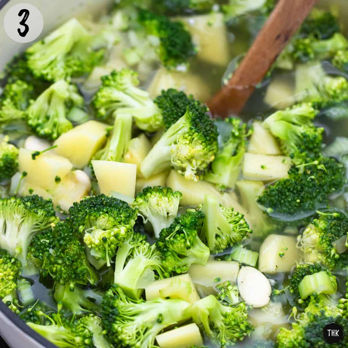 Large pot with broccoli, potatoes, almonds, and broth.