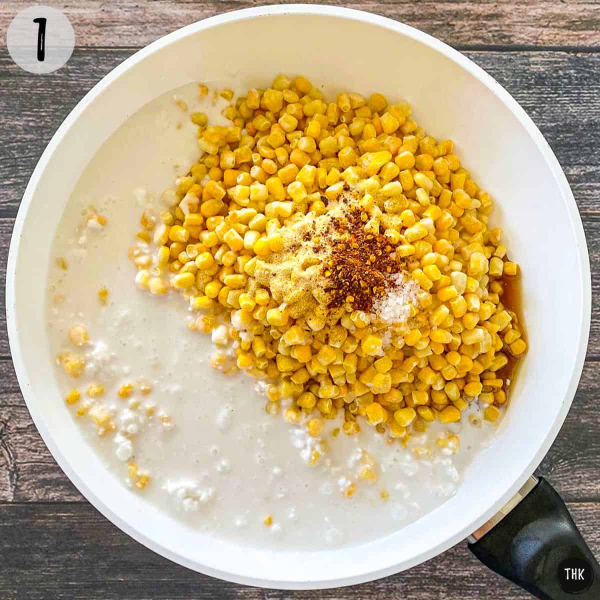 Corn, coconut milk, and spices inside large skillet.