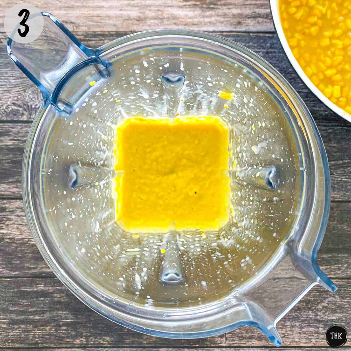 Pureed yellow mixture inside blender.