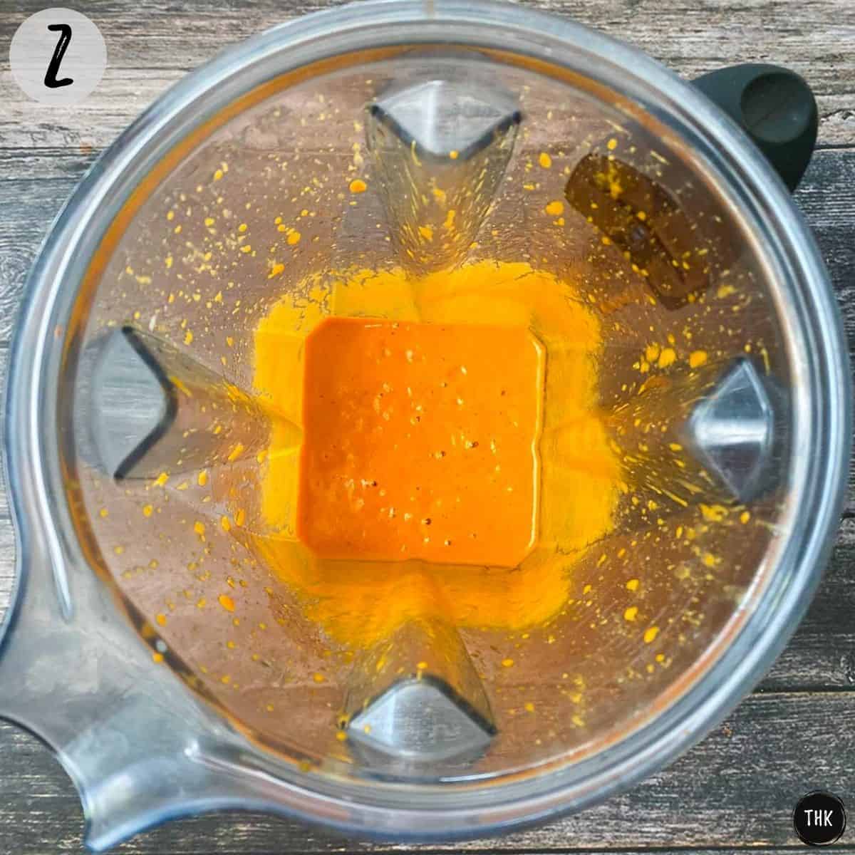 Orange mixture inside blender.